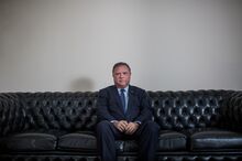 A portrait of Blairo Maggi sitting on a couch.