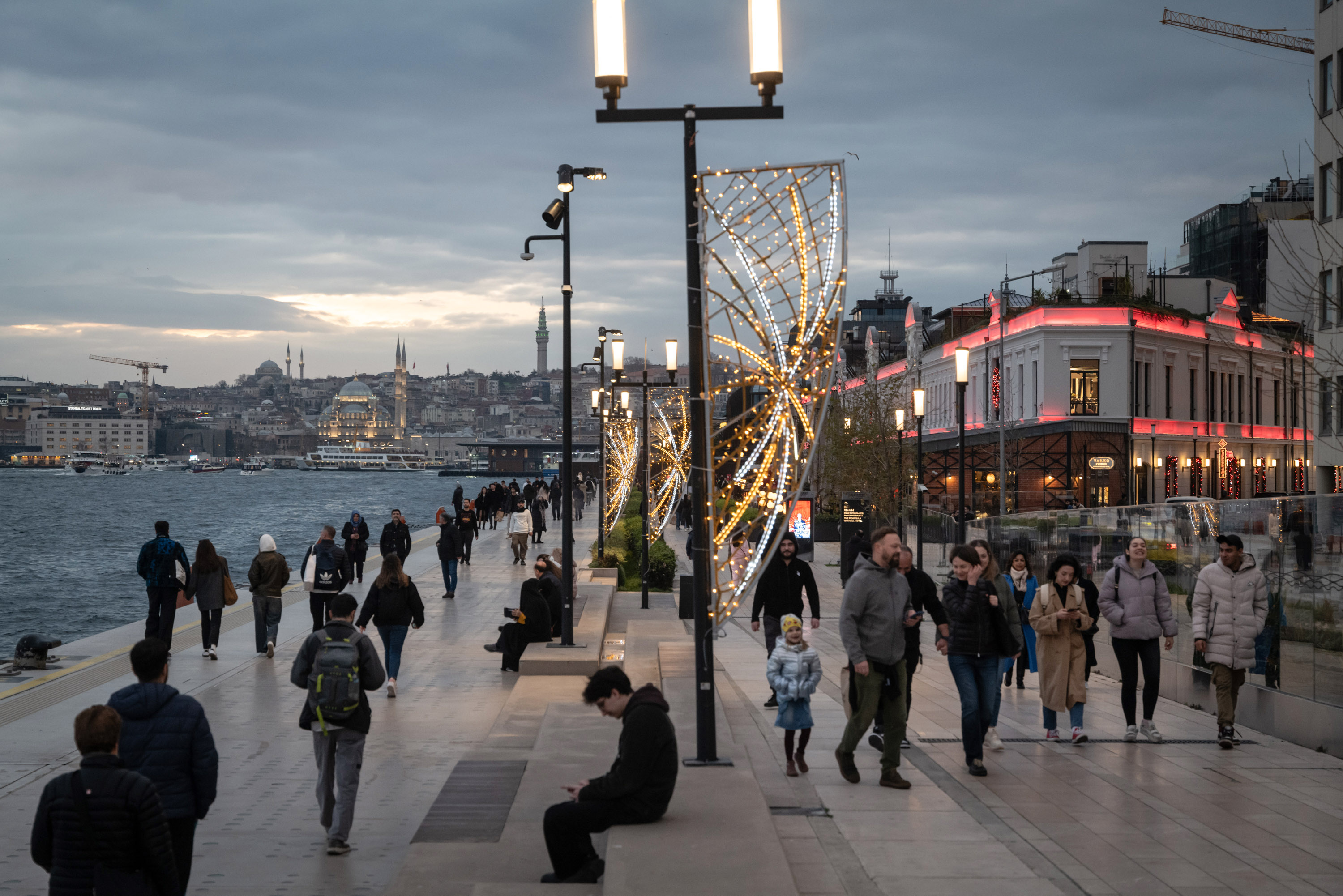 Pedestrians along the banks of the Bosphorus strait in Istanbul.