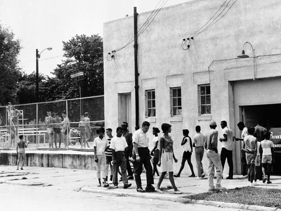 African American youths marched in front of a segregated swimming pool in Cairo, Illinois, on July 23, 1962, protesting the all-white policy of the pool. 