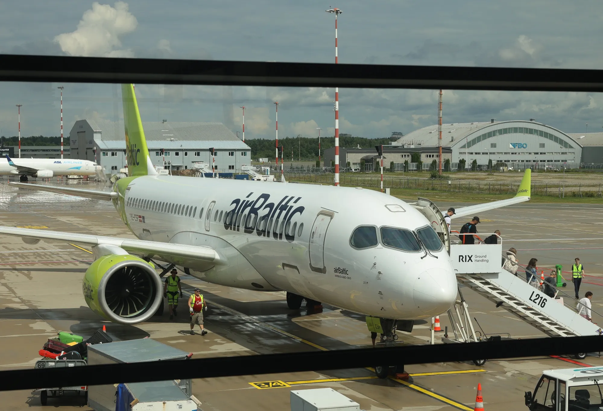 Passengers disembark an Air Baltic Corp., aircraft at Riga International Airport, in Riga, Latvia.