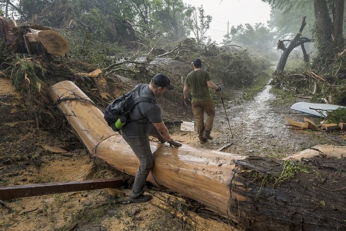 Volunteers search for missing people along the banks of the Guadalupe River in Hunt, Texas, on July 6.