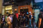 Police officers enter a bar in the Lan Kwai Fong nightlife area announcing patrons would have to show proof of a negative Covid-19 test.