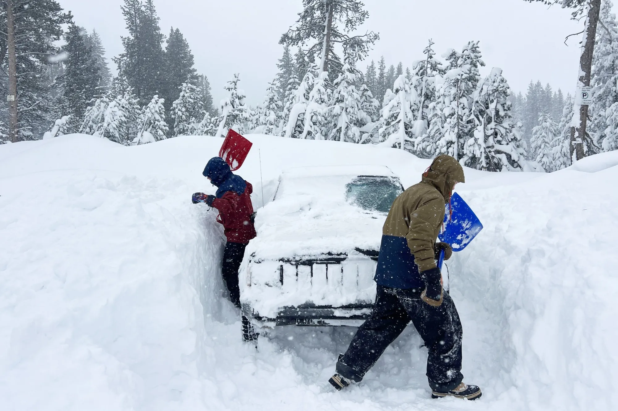 Residents dig their vehicle out of snow in Donner Summit, California on Feb. 18.