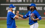 Rafael Dolis, right, of the Toronto Blue Jays celebrates with a member of the coaching staff during a game on July 21.