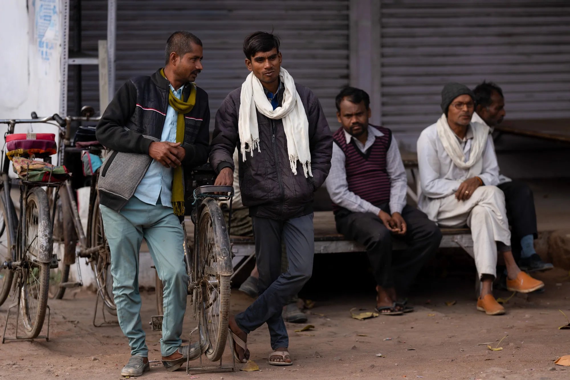 People wait for daily wage work along a street in Atarra, in Uttar Pradesh, India.