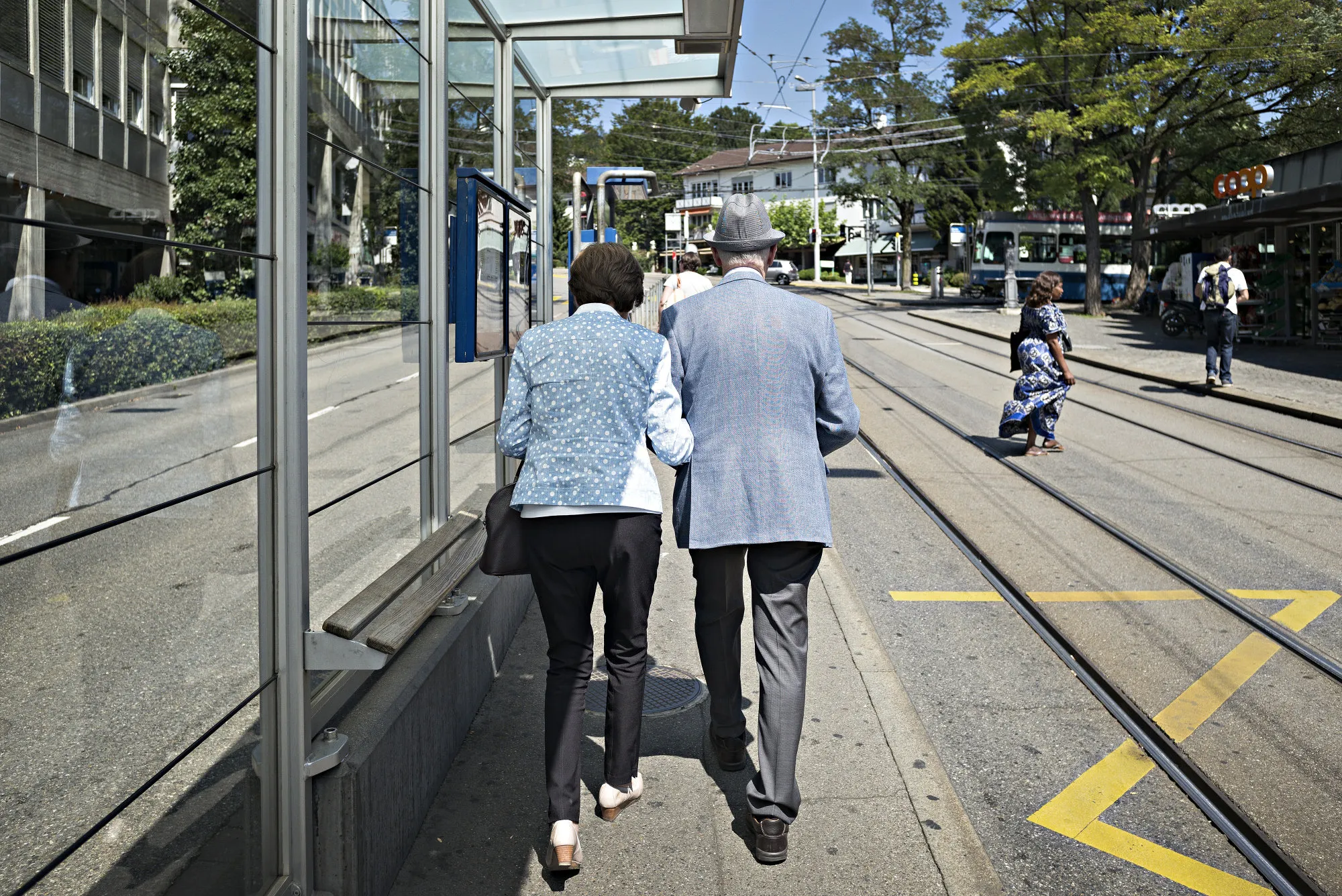 An elderly couple walk arm-in-arm in Zurich, Switzerland.