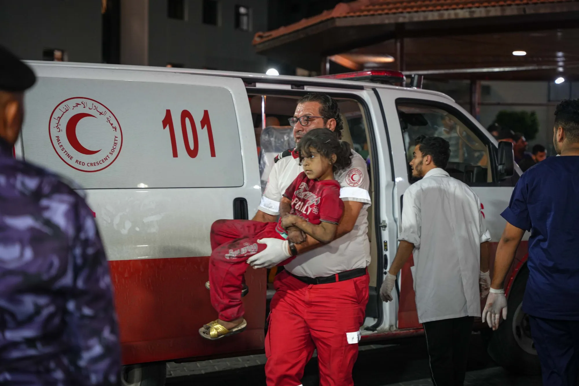 An emergency worker carries an injured child to hospital following Israeli airstrikes in the Rimal district west of Gaza City, Gaza.