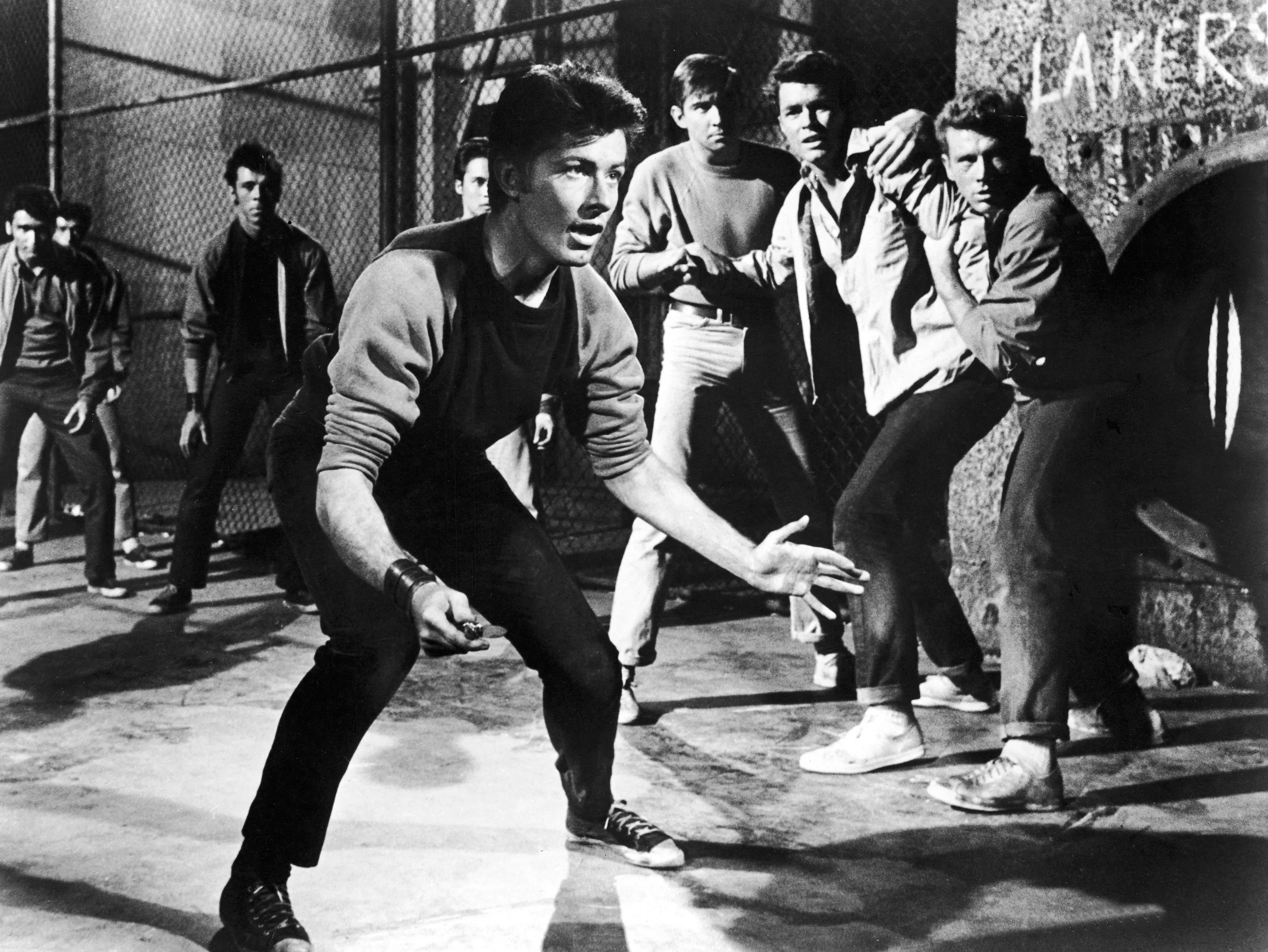 George Chakiris holds a switchblade open, ready to fight a rival gang in a still from the musical film, 'West Side Story,' directed by Jerome Robbins and Robert Wise, 1961. Source: United Artists via Getty Images
