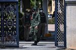 Policemen and army personnel patrol at the Army Training Command in Bangkok on Sept. 14.