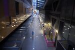 A woman walks along a deserted lane in the Queen Victoria Village precinct in Melbourne, Australia, on July 16.