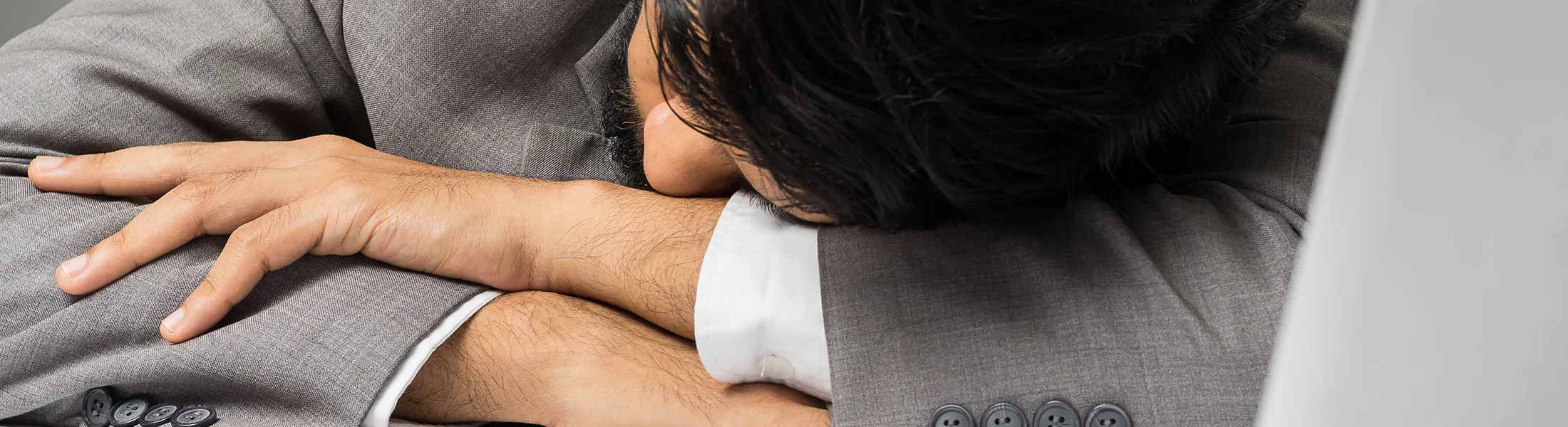 Businessman sleeping on work desk.