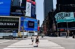 Pedestrians pass through an empty Times Square New York, U.S., on Tuesday, June 9, 2020. 