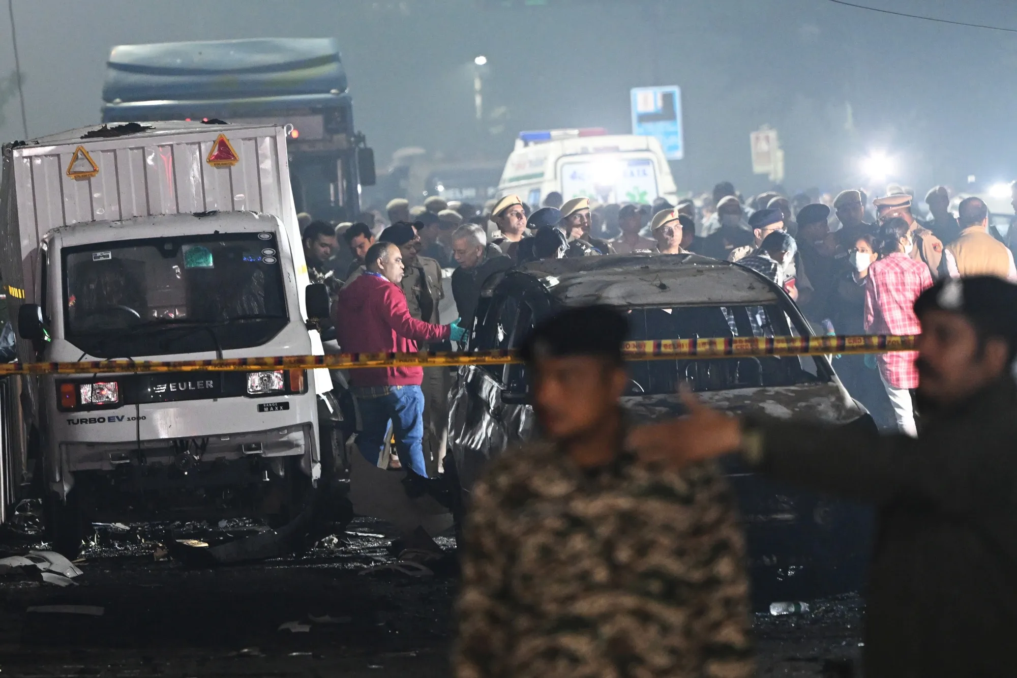 Security officials near destroyed vehicles at the site of an explosion in New Delhi on Nov. 10.