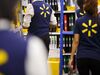 Employees restock shelves at Wal-Mart