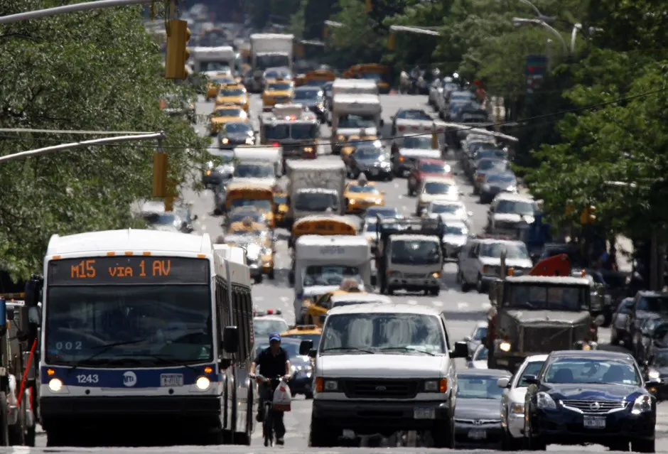 A New York City bus in its usual habitat: stuck in heavy traffic.