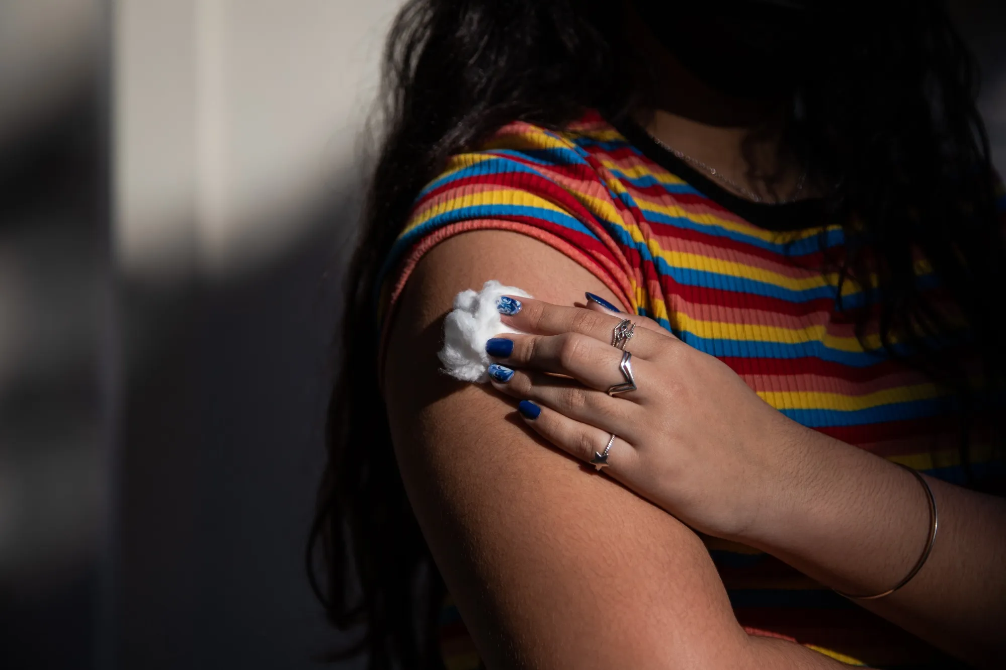 A young resident of Paqueta Island holds a piece of cotton on her arm after receiving a dose of the Pfizer-BioNTech Covid-19 vaccine on Paqueta Island, Rio de Janeiro state, Brazil.