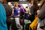 Tampa resident Kristy Simon waits in line to check into a Spirit Airlines flight