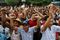 National League for Democracy party supporters cheer as they gather outside the party headquarters in Yangon, Myanmar, on Sunday, Nov. 8, 2015. Photographer: Dario Pignatelli/Bloomberg