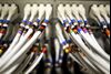 Data cables feed into a server inside a comms room at an office in London, U.K.