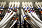 Data cables feed into a server inside a comms room at an office in London, U.K.
