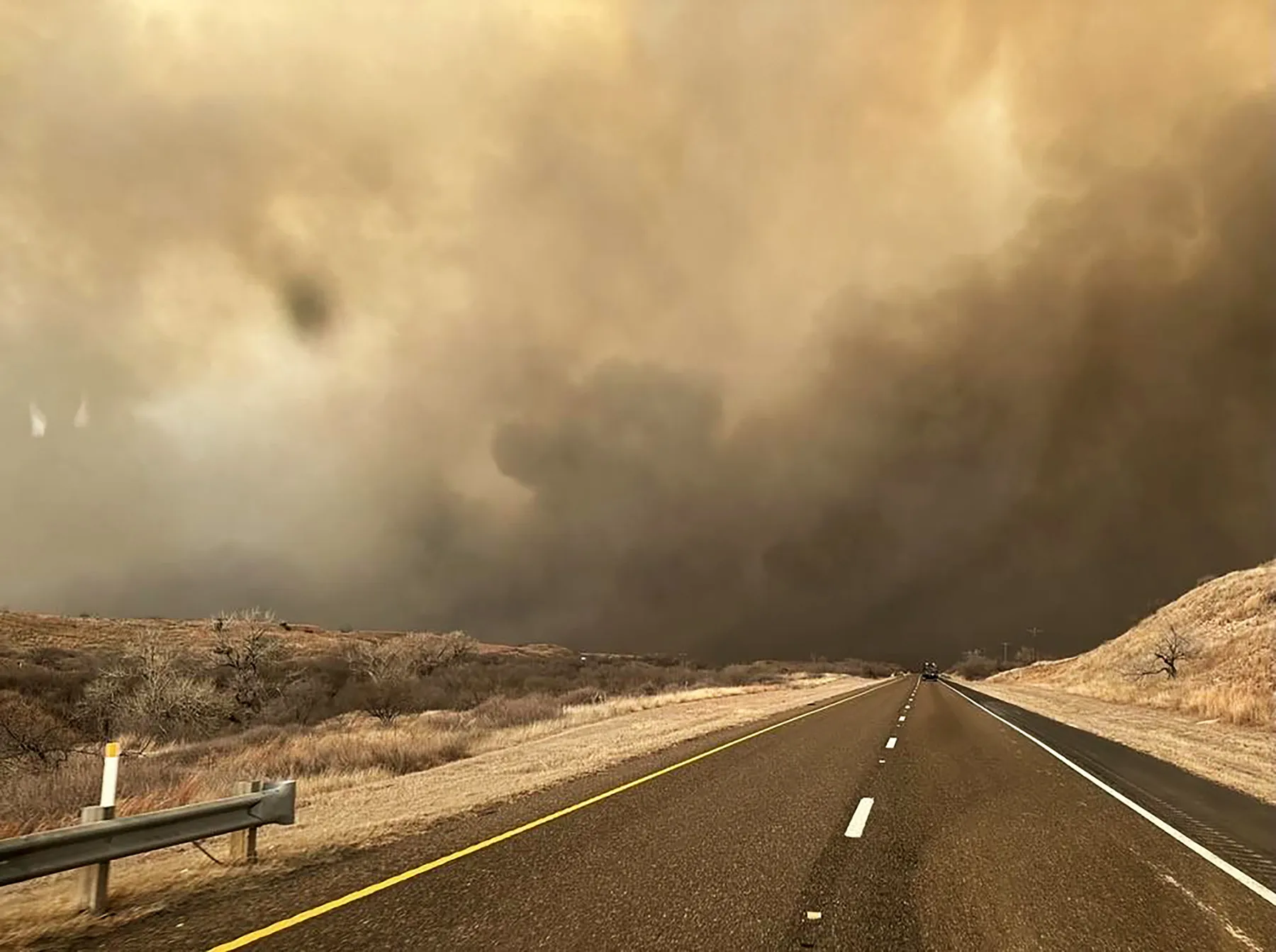 Smoke billows over a road during the Smokehouse Creek fire&nbsp;in the Texas panhandle on February 27.&nbsp;