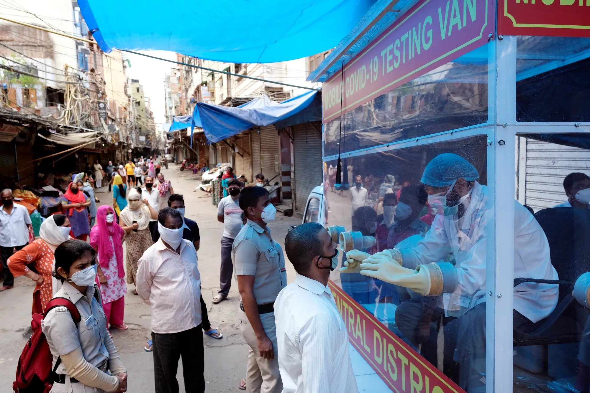 Residents at a mobile Covid-19 testing van operating in New Delhi, India. Photographer. T. Narayan/Bloomberg