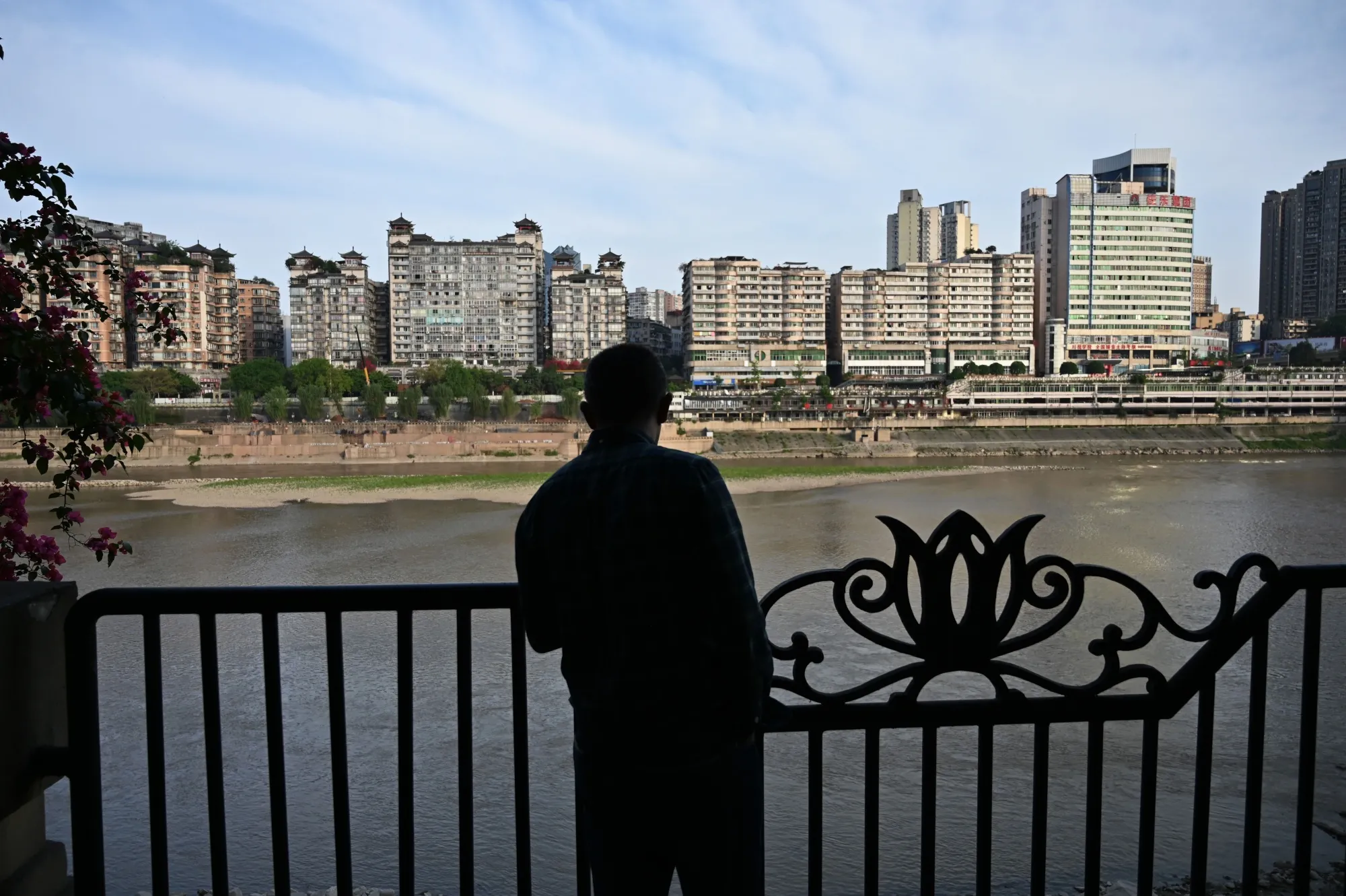 A man looks at to the Tuo River, in the city of Luzhou