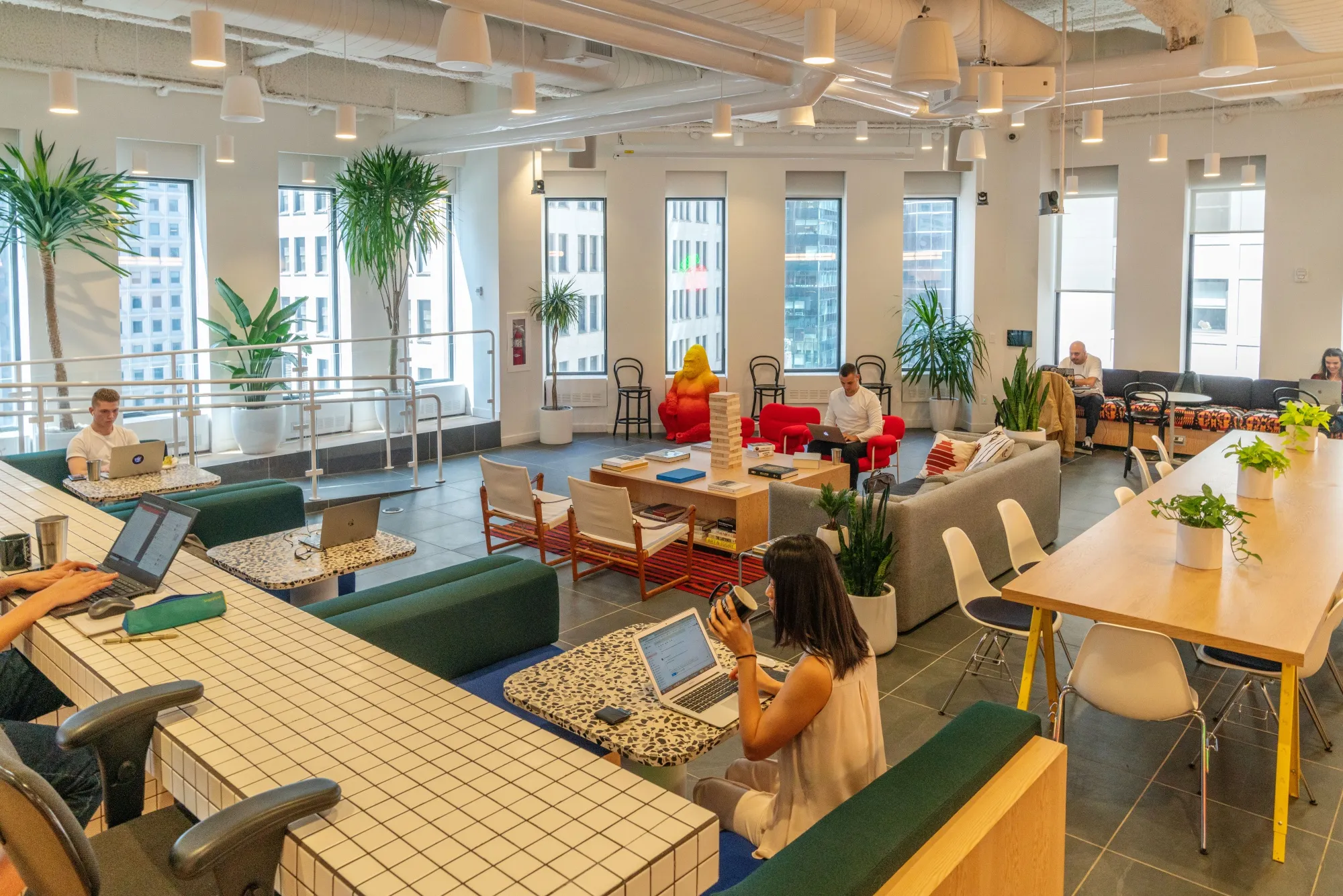 Members work in the cafeteria at the WeWork Cos Inc. 85 Broad Street offices in&nbsp;New York.