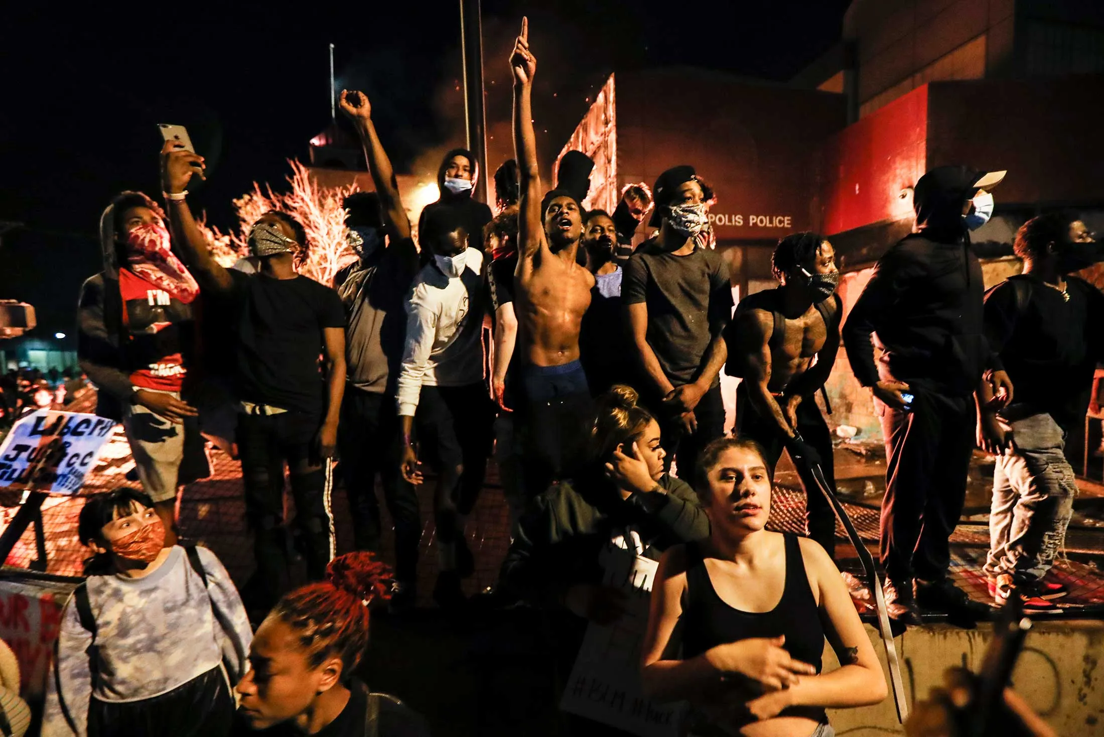 Protesters demonstrate outside the&nbsp;burning 3rd Police Precinct in Minneapolis on&nbsp;Thursday,&nbsp;May 28.&nbsp;