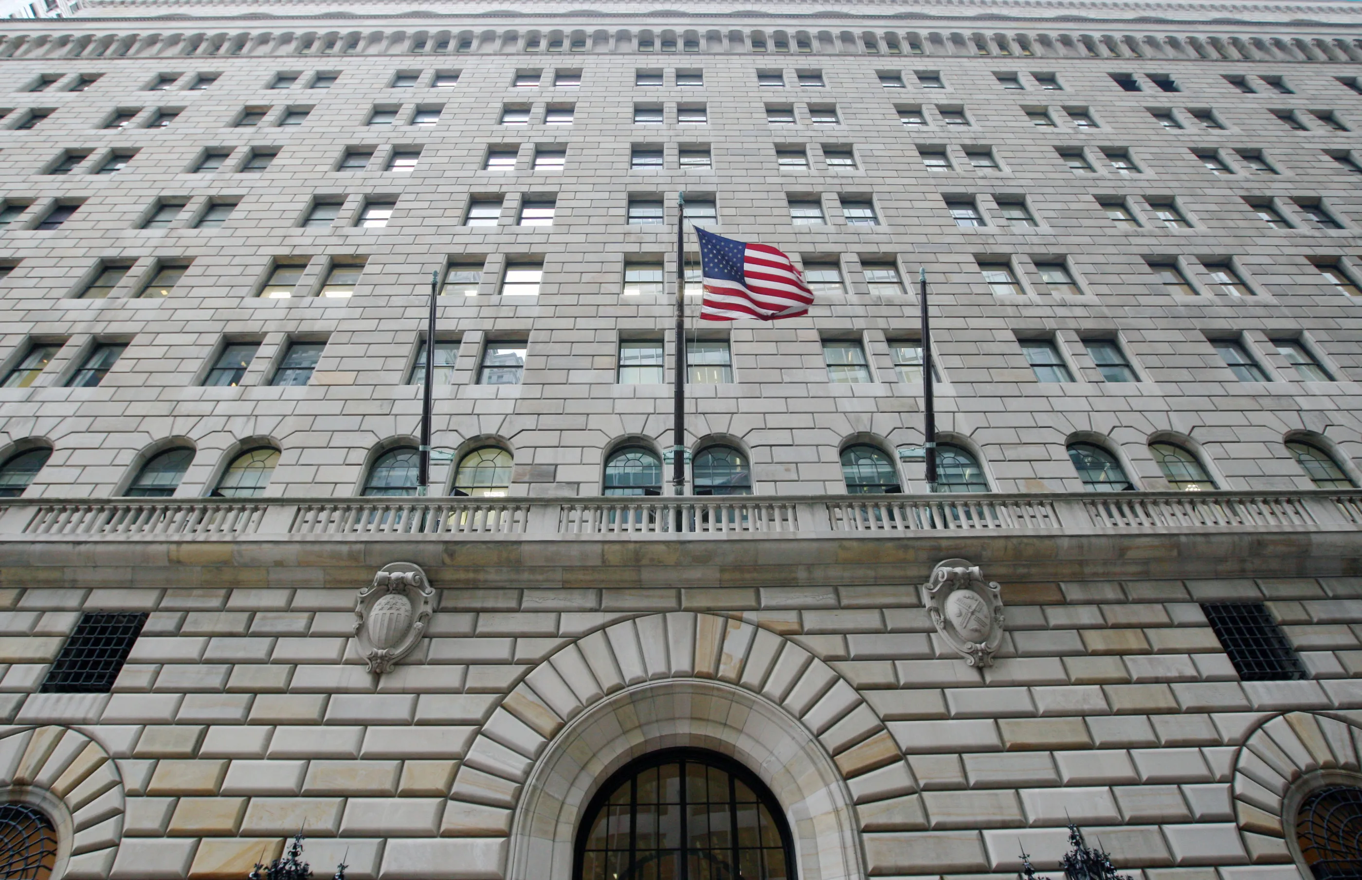 The U.S. flag hangs on the facade of the Federal Reserve Bank of New York headquarters in New York, U.S.