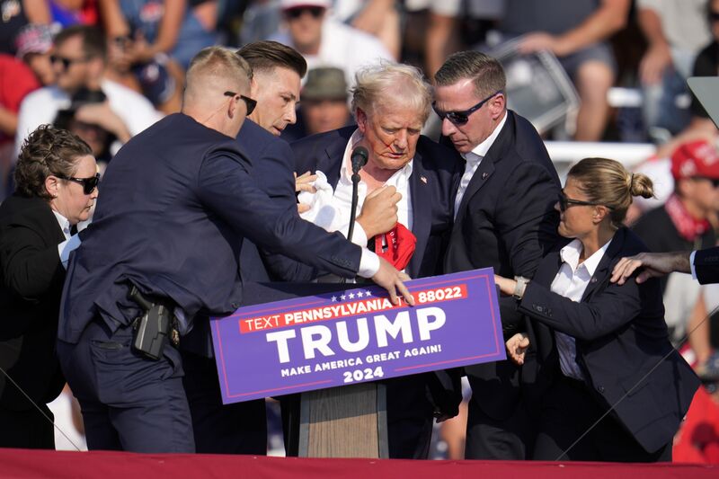 Donald Trump surrounded by US Secret Service agents at a campaign rally in Butler, Pennsylvania, on July 13.