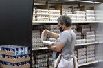 A shopper checks a carton of eggs inside a grocery store in San Francisco, California, U.S.