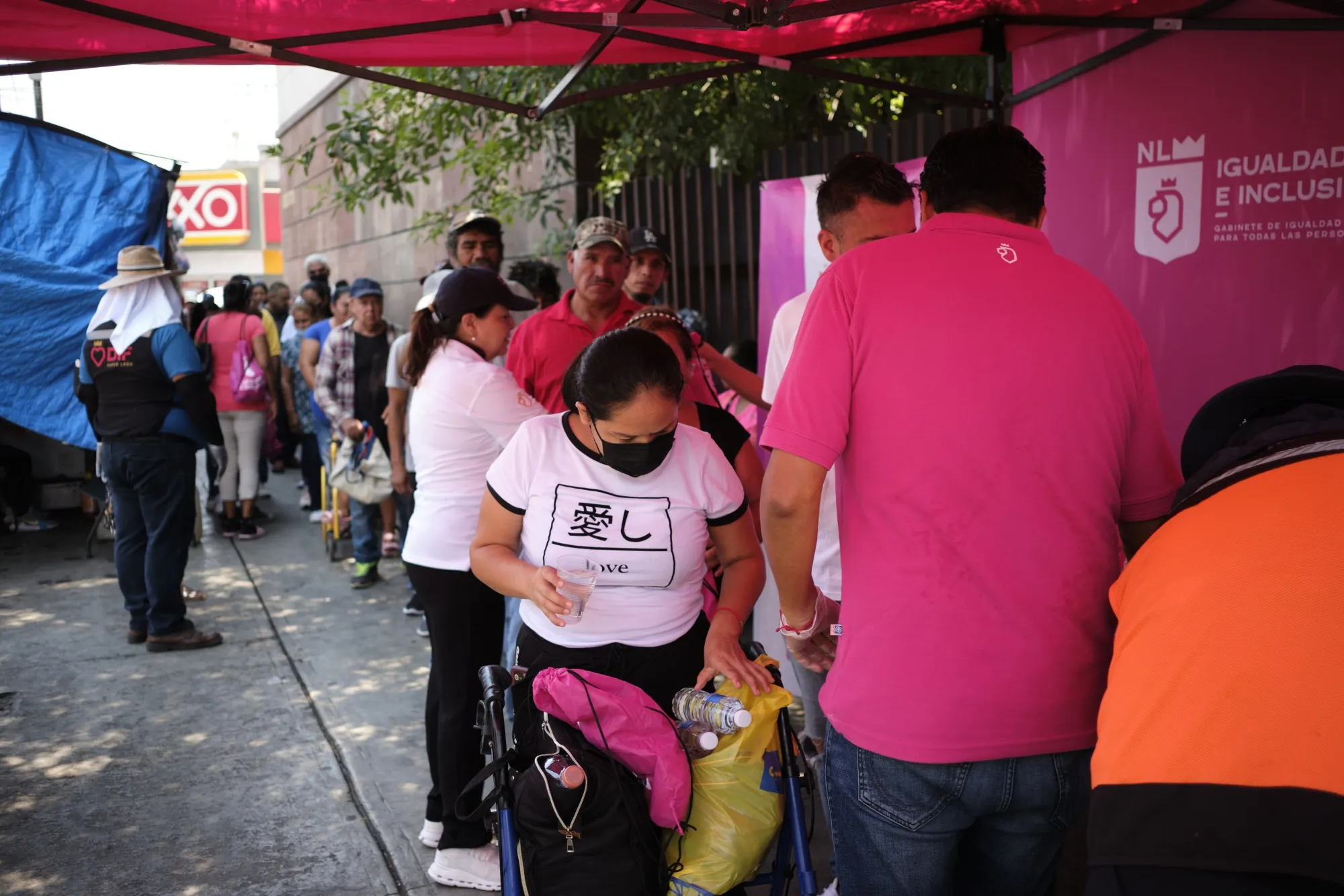 Residents wait in line outside a hospital to receive water bottles during a heat wave in Monterrey, Nuevo Leon state, Mexico, on June 22, 2023.&nbsp;