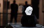 Guards stand next to the 1109-carat rough Lesedi La Rona diamond at Sotheby's in New York, on May 4, 2016.
