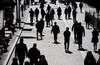 Pedestrians walk past the New York Stock Exchange (NYSE) in New York, U.S.