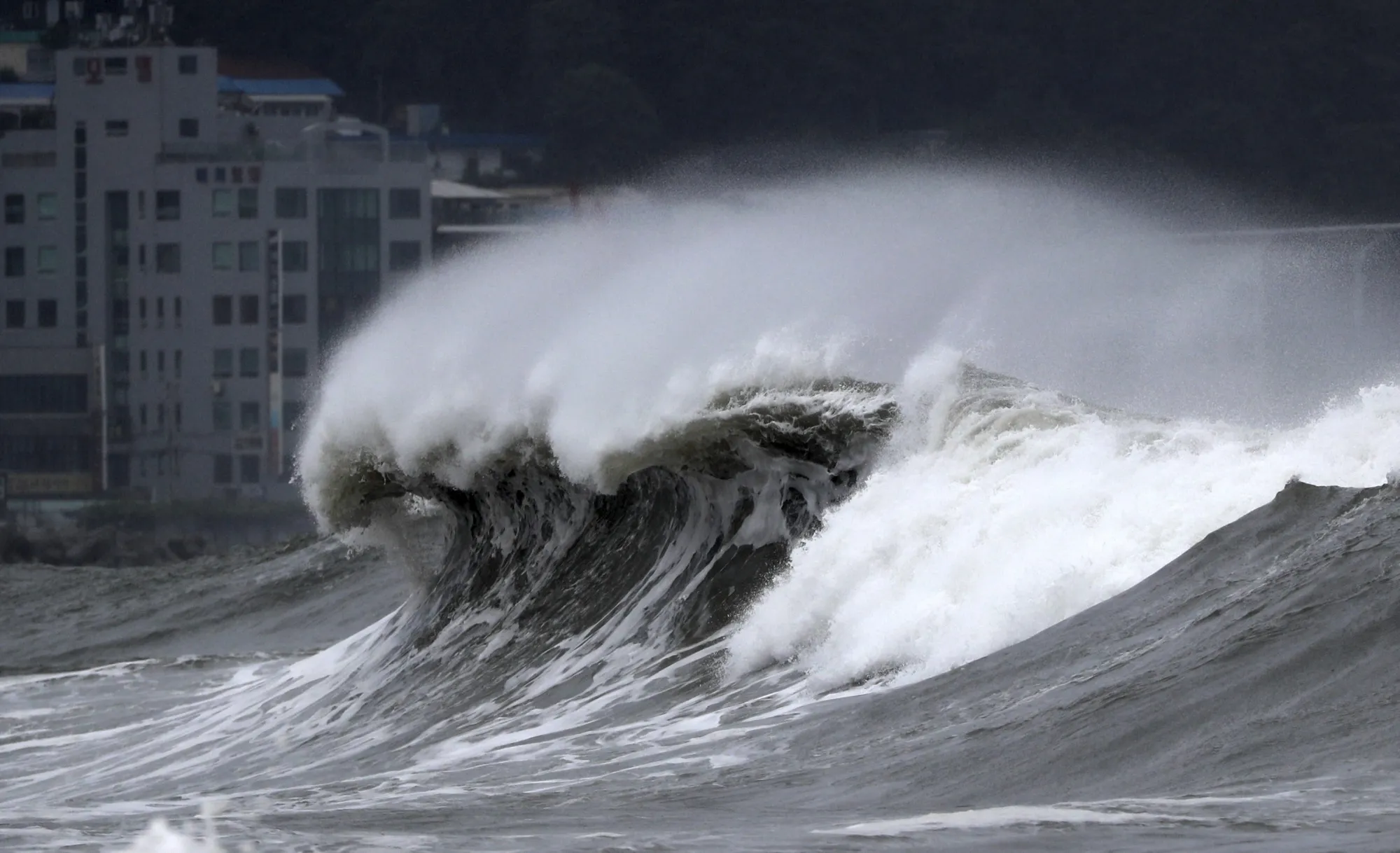 High waves crash onto a beach in Busan, South Korea, as Typhoon Hinnamnor approaches the Korean Peninsula on Monday, Sept. 5, 2022. Hundreds of flights were grounded and more than 200 people evacuated in South Korea on Monday as Typhoon Hinnamnor approached the southern region with heavy rains and winds of up to 170 kilometers (105 miles) per hour, putting the nation on alert for its worst storm in decades. (Son Hyung-joo/Yonhap via AP)