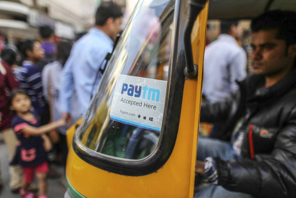 A sign for PayTM online payment on the front windscreen of an auto rickshaw in Bengaluru, India.