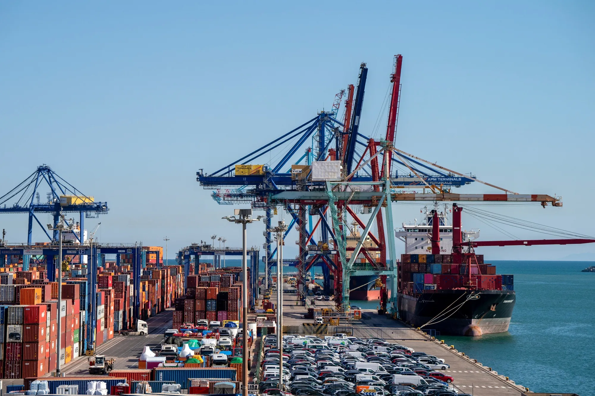 A container ship is off loaded at the main port of Valencia, Spain.