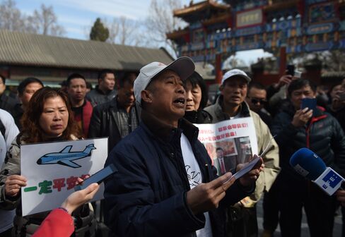 Relatives of Flight 370 victims gather outside Lama Temple in Beijing.