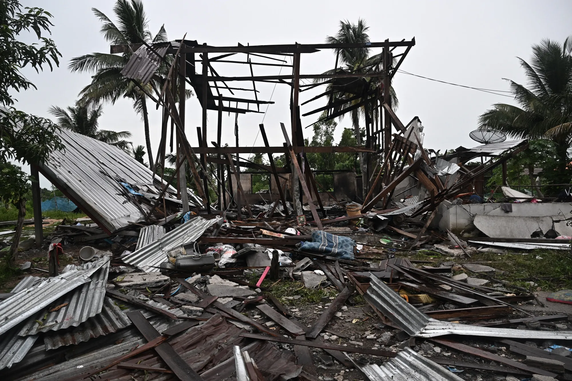 An evacuated house destroyed by fire after being hit by Cambodian artillery in the Thai border province of Surin.