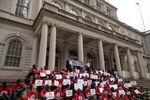 Ride-share drivers and supporters with the Independent Drivers Guild protest outside New York City Hall as they rally for wage enforcement and a drivers' bill of rights.