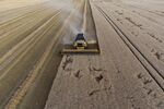 A combine harvester cuts through a field of wheat during the summer harvest in Heudicourt, France.