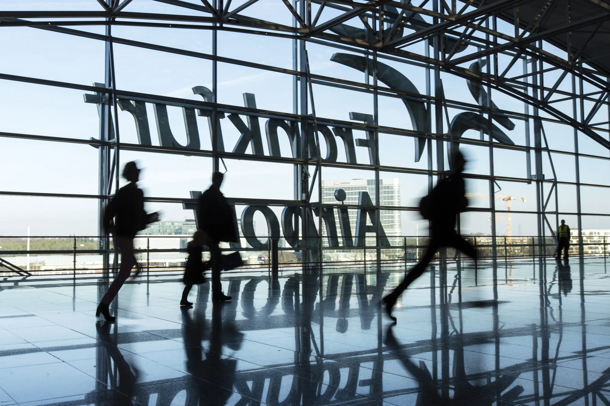 Passengers run for flights inside Terminal 2 at Frankfurt Airport, operated by Fraport AG, in Frankfurt.