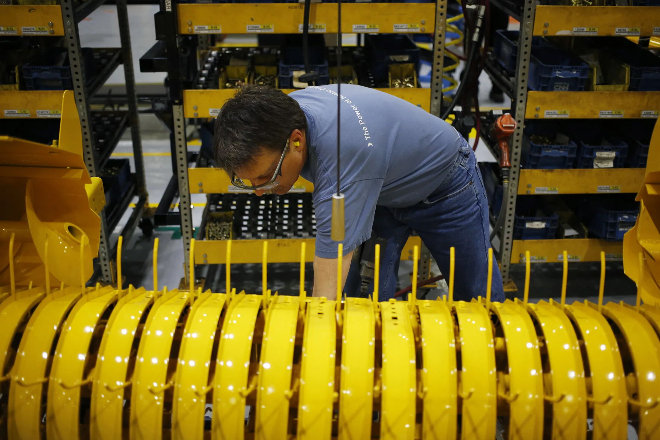 A worker assembles components.
