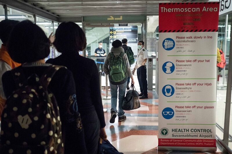 Public health officials run thermal scans on passengers arriving from Wuhan, China at Suvarnabumi Airport in Bangkok, Thailand on Jan 8. 