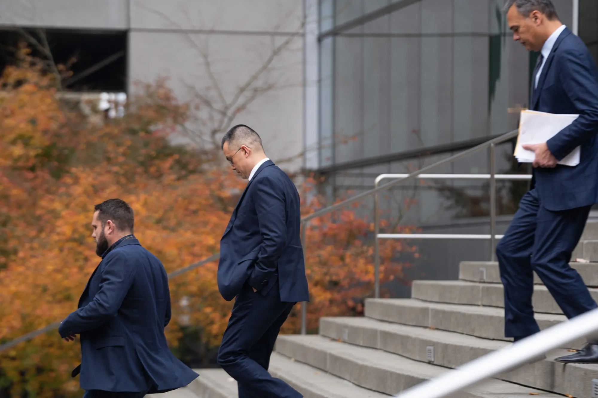 Changpeng Zhao, CEO of Binance, center, exits federal court in Seattle, Washington, on Nov. 21. Zhao&nbsp;pleaded guilty to anti-money laundering and US sanctions violations under a sweeping settlement.&nbsp;