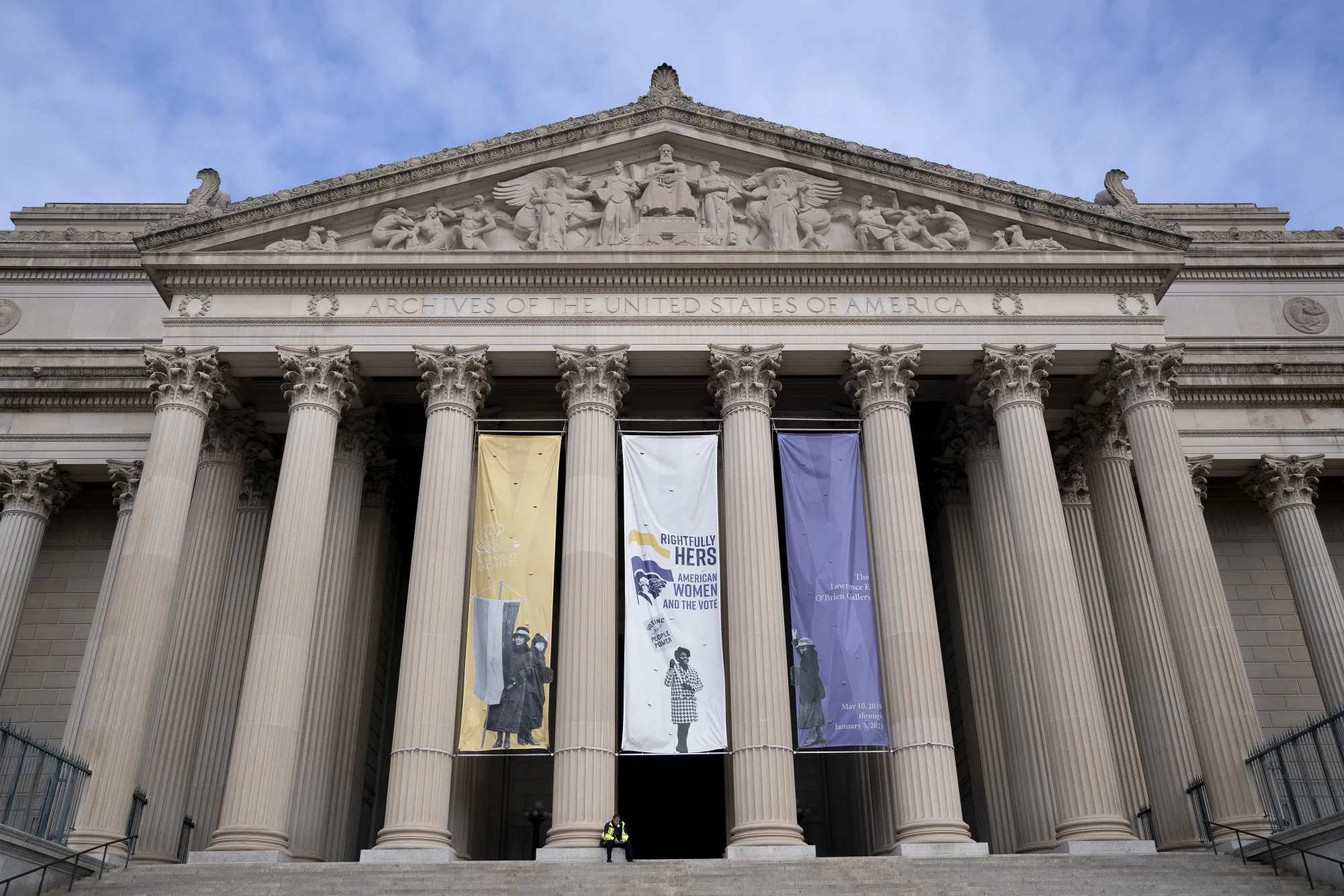 A security worker sits at the National Archives along the National Mall in Washington, D.C., U.S., on Monday, Jan. 18, 2021.&nbsp;
