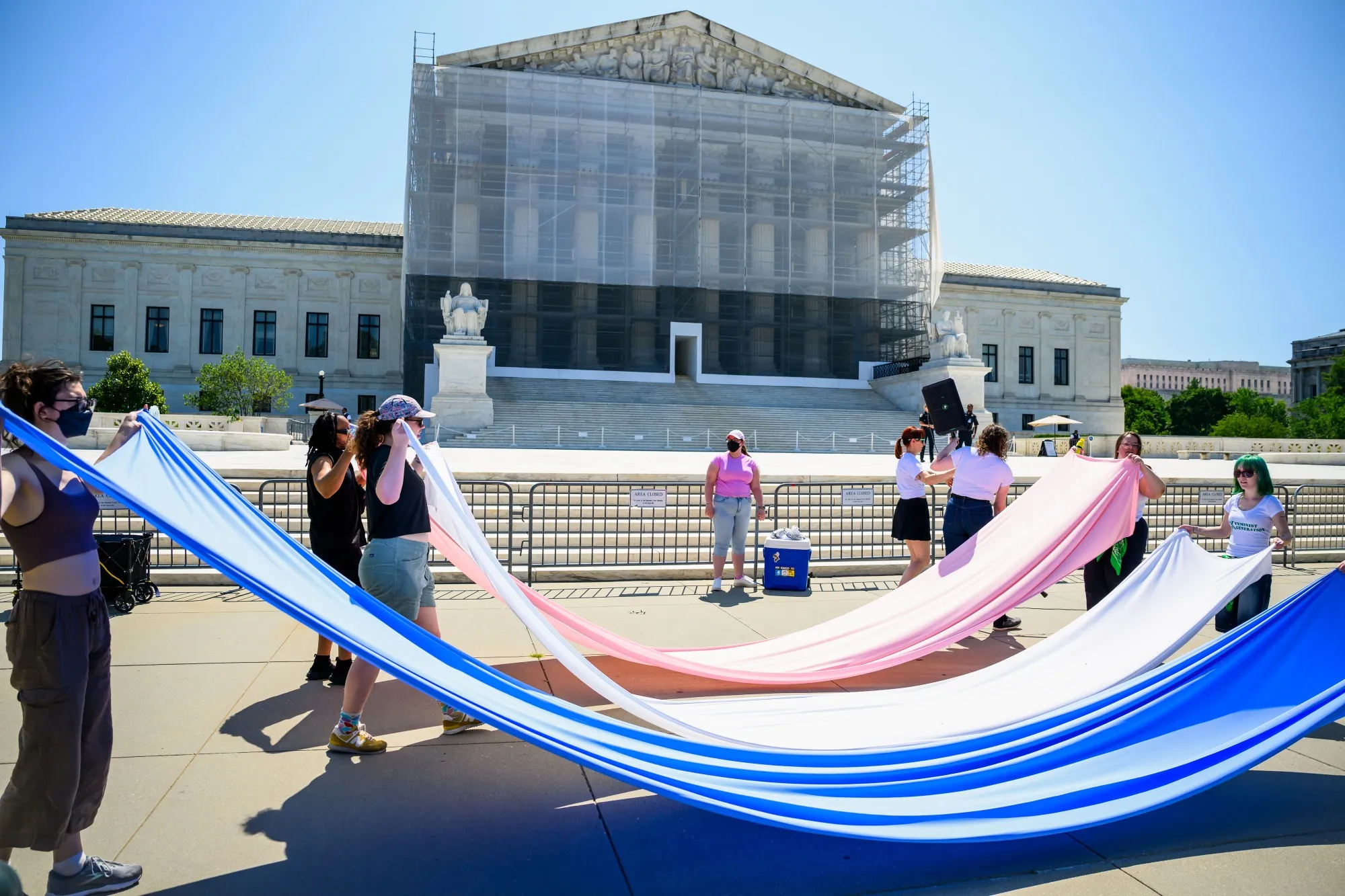 Demonstrators with Gender Liberation Movement display a transgender pride flag outside the US Supreme Court in Washington, DC.