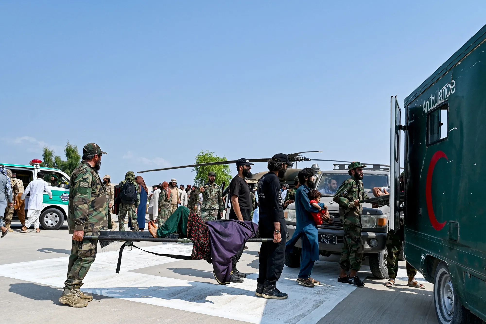 Taliban security personnel transfer an earthquake victim from the Nurgal district of Kunar province, to an ambulance, in Jalalabad, on Sept. 1.