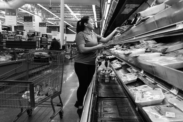 Nunez shops in the meat aisle for groceries at a local Walmart in Moultrie 